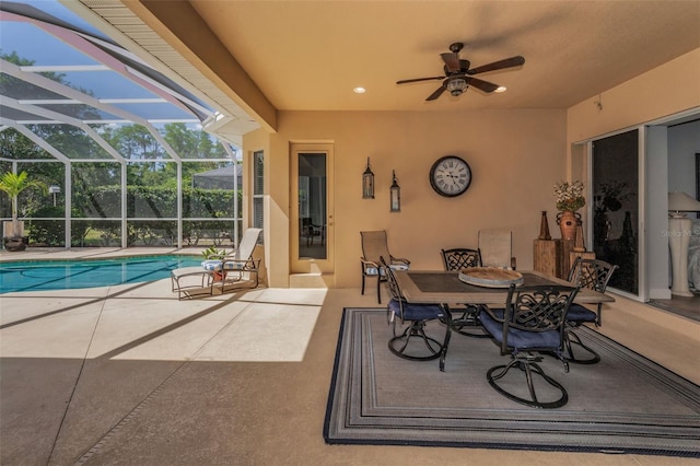 1033 Tuscany Dr, Trinity, FL 34655 - view of patio featuring outdoor dining area, ceiling fan, an outdoor pool, and glass enclosure