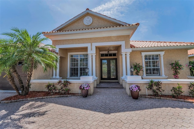 1033 Tuscany Dr, Trinity, FL 34655 - view of front of property with french doors and stucco siding