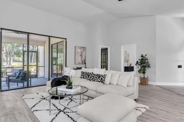 3047 Bolt Dr, Palm Harbor, FL 34685 - living room with baseboards, wood finished floors, and high vaulted ceiling