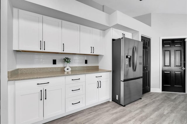 3047 Bolt Dr, Palm Harbor, FL 34685 - kitchen featuring light wood-style floors, white cabinetry, and stainless steel fridge with ice dispenser