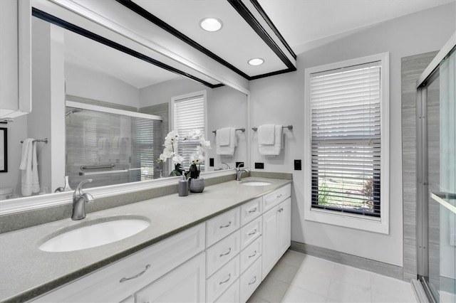 3047 Bolt Dr, Palm Harbor, FL 34685 - full bath featuring baseboards, a sink, double vanity, and a stall shower