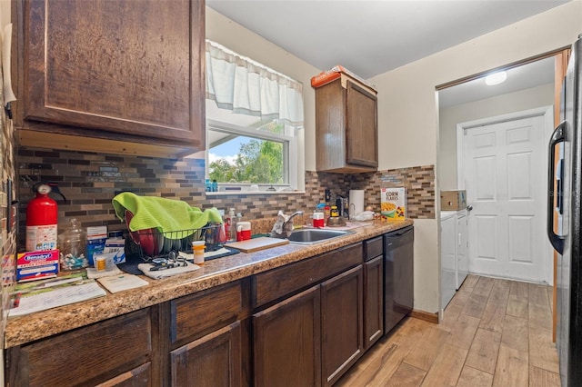 9640 Northcliffe Blvd, Spring Hill, FL 34608 - kitchen featuring dark brown cabinetry, separate washer and dryer, light wood-style flooring, decorative backsplash, and black appliances