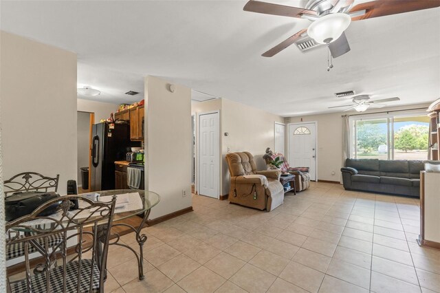 9640 Northcliffe Blvd, Spring Hill, FL 34608 - living room with baseboards, visible vents, a ceiling fan, and light tile patterned flooring
