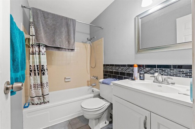 9640 Northcliffe Blvd, Spring Hill, FL 34608 - bathroom featuring toilet, tile walls, tile patterned floors, shower / bathtub combination with curtain, and vanity