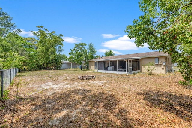 9640 Northcliffe Blvd, Spring Hill, FL 34608 - view of yard featuring a fire pit, a fenced backyard, and a sunroom