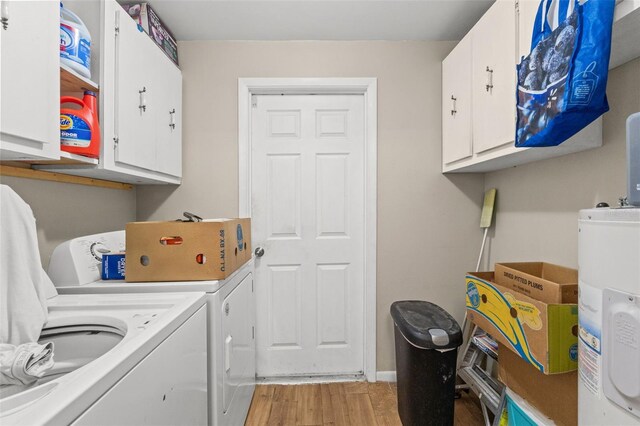 9640 Northcliffe Blvd, Spring Hill, FL 34608 - laundry room with light wood finished floors, cabinet space, washing machine and clothes dryer, and electric water heater