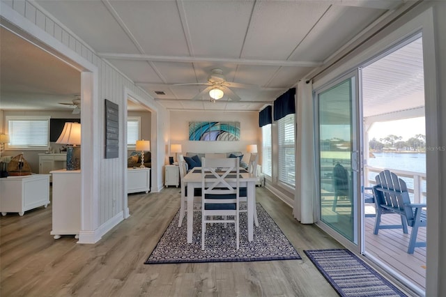 6622 Seaview Blvd, Hudson, FL 34667 - dining room with ceiling fan, wood finished floors, a water view, and plenty of natural light