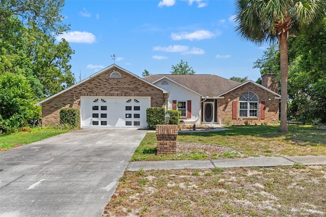 13469 Pia Ct, Spring Hill, FL 34609 - single story home with a chimney, a front yard, brick siding, concrete driveway, and an attached garage