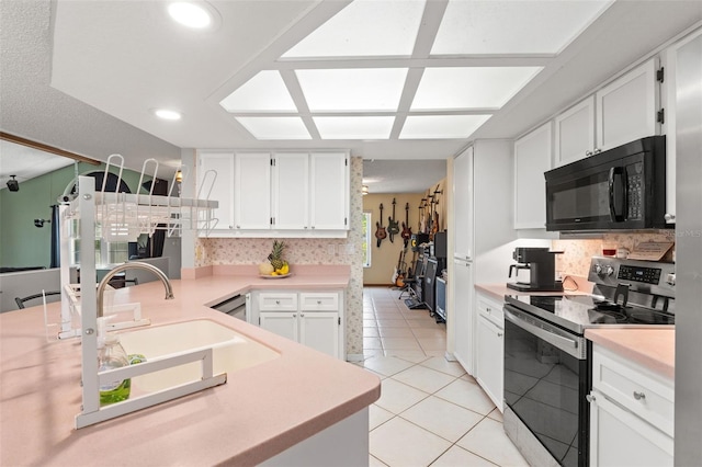 13469 Pia Ct, Spring Hill, FL 34609 - kitchen featuring black microwave, stainless steel electric range oven, tasteful backsplash, light tile patterned floors, and a sink