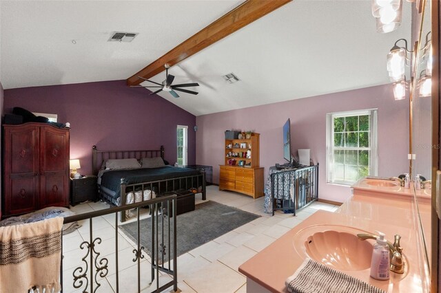 13469 Pia Ct, Spring Hill, FL 34609 - bedroom with ceiling fan, visible vents, a sink, light tile patterned floors, and vaulted ceiling with beams