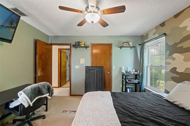 13469 Pia Ct, Spring Hill, FL 34609 - bedroom with visible vents, a textured ceiling, ceiling fan, and light carpet