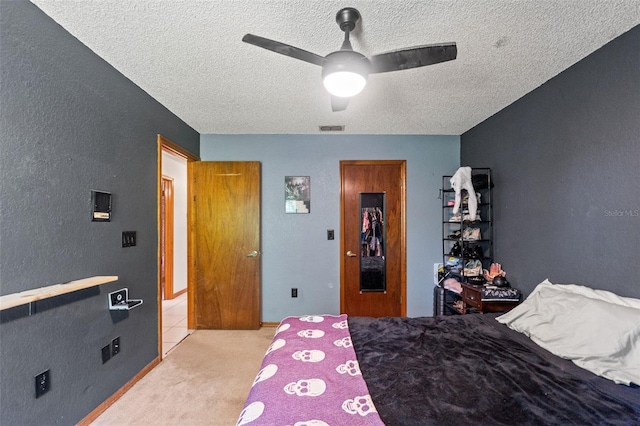 13469 Pia Ct, Spring Hill, FL 34609 - bedroom with a ceiling fan, a textured ceiling, visible vents, a textured wall, and light carpet
