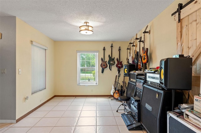 13469 Pia Ct, Spring Hill, FL 34609 - interior space featuring light tile patterned floors, a textured ceiling, a barn door, and baseboards