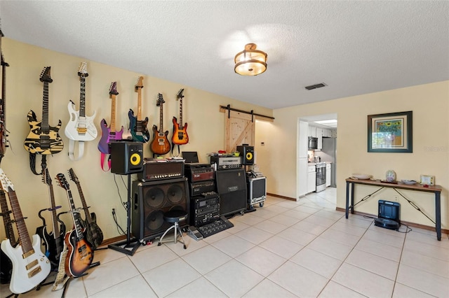 13469 Pia Ct, Spring Hill, FL 34609 - interior space with visible vents, a barn door, a textured ceiling, and baseboards