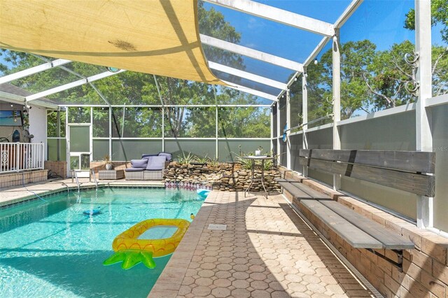 13469 Pia Ct, Spring Hill, FL 34609 - outdoor pool with glass enclosure, a patio, and outdoor lounge area
