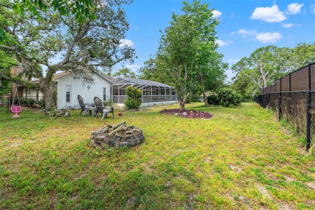 13469 Pia Ct, Spring Hill, FL 34609 - view of yard with glass enclosure, an outdoor fire pit, and fence