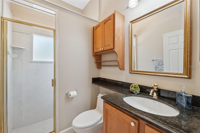 bathroom with toilet, vanity, and a shower stall