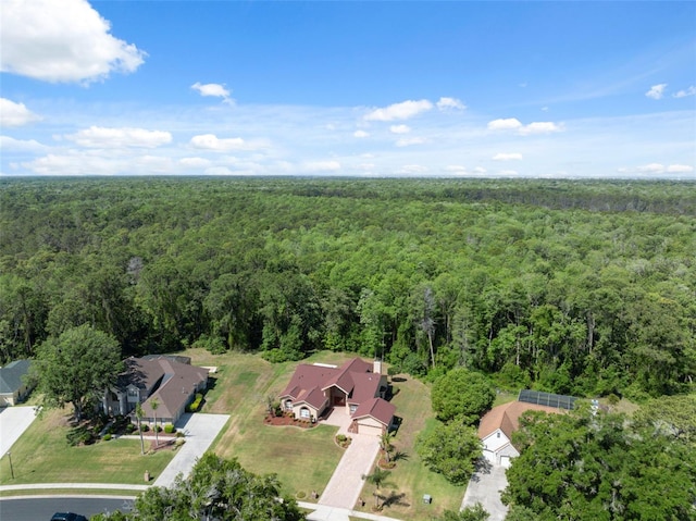 birds eye view of property featuring a view of trees