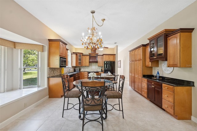 dining area with light tile patterned flooring, a chandelier, and baseboards