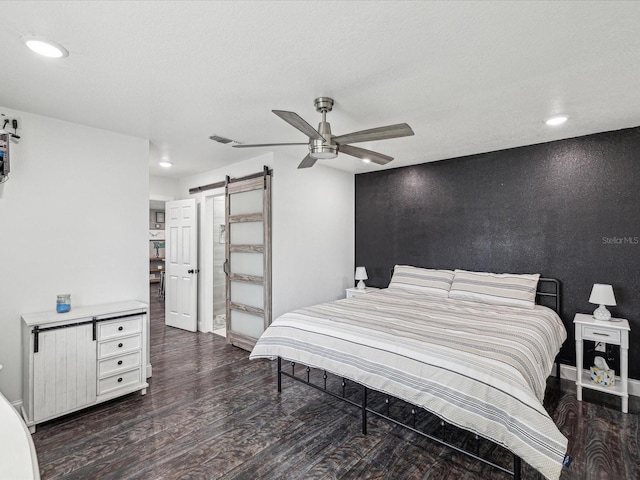 bedroom featuring a barn door, visible vents, recessed lighting, wood finished floors, and a ceiling fan
