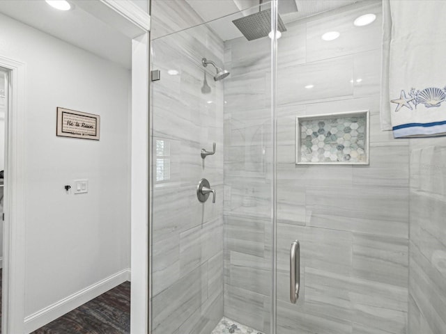 bathroom featuring baseboards and a stall shower