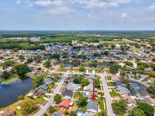 drone / aerial view featuring a water view and a residential view