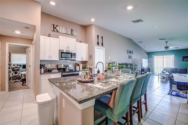 680 Argyll Dr, Spring Hill, FL 34609 - kitchen with stainless steel appliances, a kitchen breakfast bar, open floor plan, stone counters, and visible vents