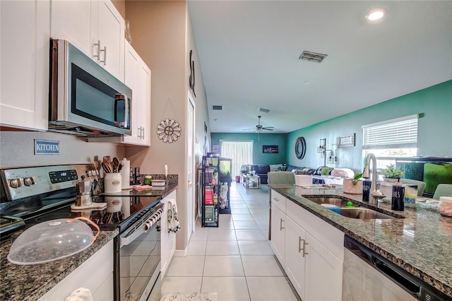 680 Argyll Dr, Spring Hill, FL 34609 - kitchen featuring dark stone countertops, a sink, open floor plan, stainless steel appliances, and visible vents