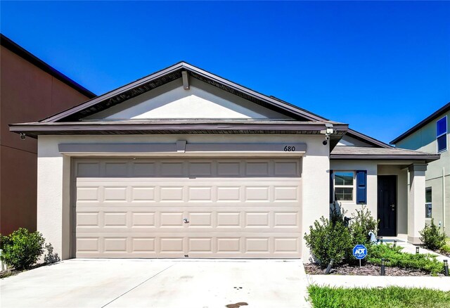 680 Argyll Dr, Spring Hill, FL 34609 - single story home with stucco siding, driveway, and a garage
