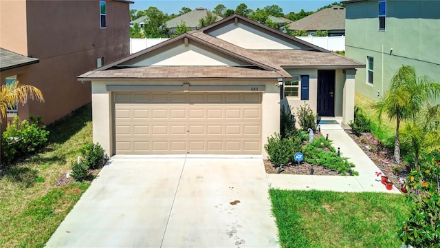 680 Argyll Dr, Spring Hill, FL 34609 - view of front of home with an attached garage, a shingled roof, stucco siding, and driveway