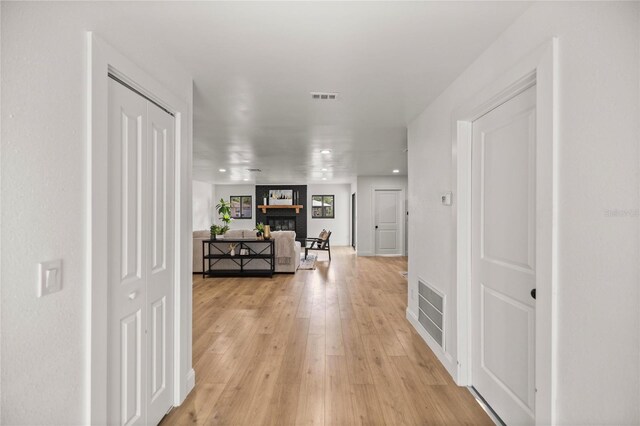 hall with visible vents and light wood-type flooring