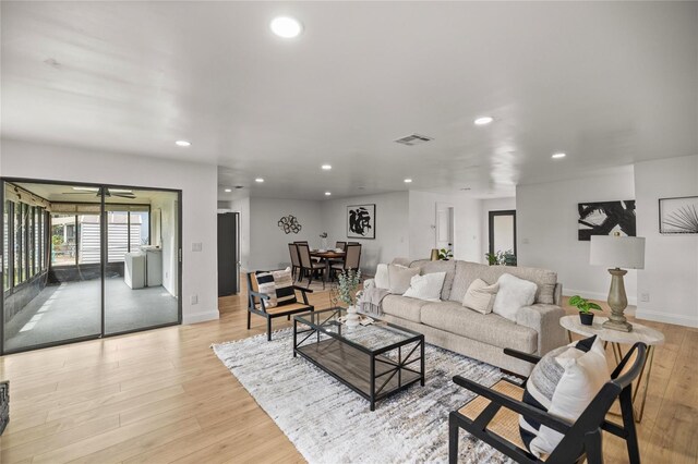 living room featuring recessed lighting, visible vents, light wood finished floors, and baseboards