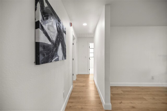 hall with recessed lighting, wood finished floors, and baseboards