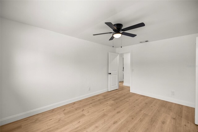 empty room with ceiling fan, baseboards, visible vents, and light wood-type flooring