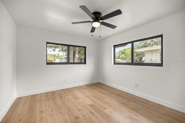 unfurnished room featuring ceiling fan, baseboards, and light wood-style floors