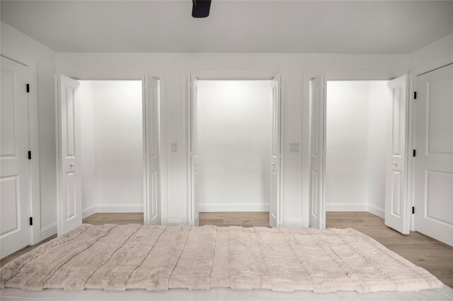 bedroom with baseboards and wood finished floors