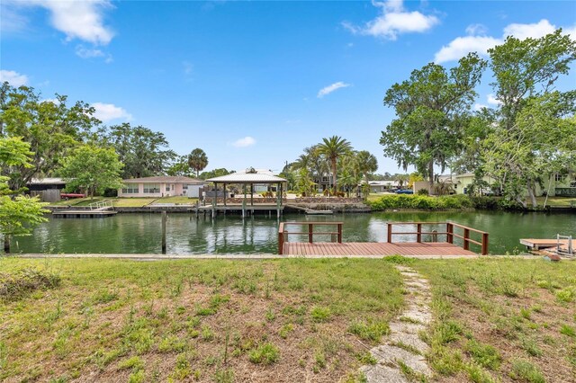view of dock with a gazebo and a water view