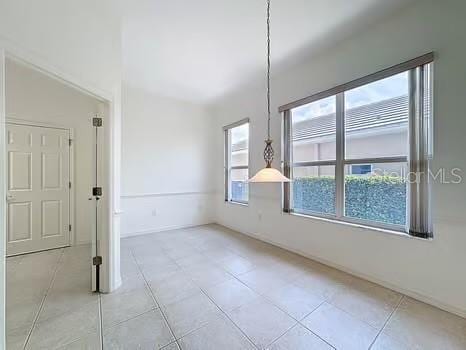 9237 Penelope Dr, Weeki Wachee, FL 34613 - unfurnished dining area featuring light tile patterned flooring
