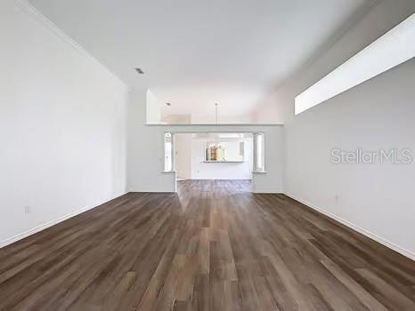 9237 Penelope Dr, Weeki Wachee, FL 34613 - unfurnished living room featuring wood finished floors