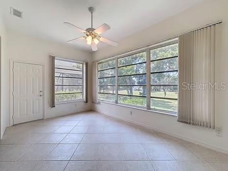 9237 Penelope Dr, Weeki Wachee, FL 34613 - tiled spare room featuring baseboards, a ceiling fan, and visible vents