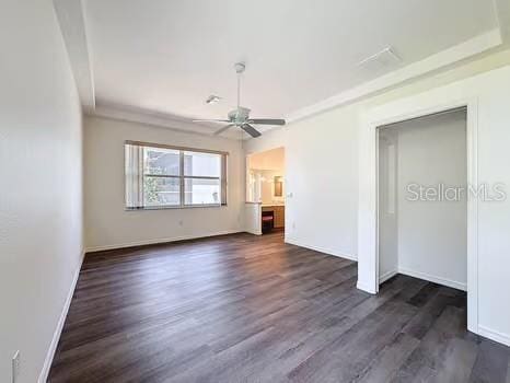 9237 Penelope Dr, Weeki Wachee, FL 34613 - unfurnished bedroom featuring baseboards, a ceiling fan, and dark wood-style floors