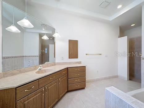 9237 Penelope Dr, Weeki Wachee, FL 34613 - bathroom featuring vanity, tile patterned flooring, and visible vents