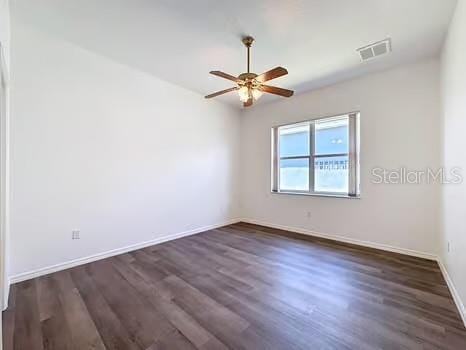 9237 Penelope Dr, Weeki Wachee, FL 34613 - spare room with baseboards, visible vents, ceiling fan, and dark wood finished floors