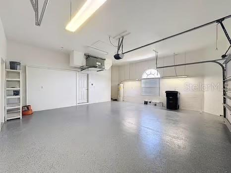 9237 Penelope Dr, Weeki Wachee, FL 34613 - garage with a garage door opener