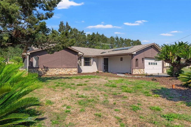3029 Harrow Rd, Spring Hill, FL 34606 - view of front of house with an attached garage, solar panels, stone siding, and stucco siding