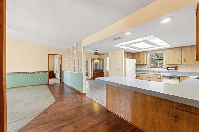 3029 Harrow Rd, Spring Hill, FL 34606 - kitchen featuring visible vents, wood finished floors, a sink, open floor plan, and white appliances