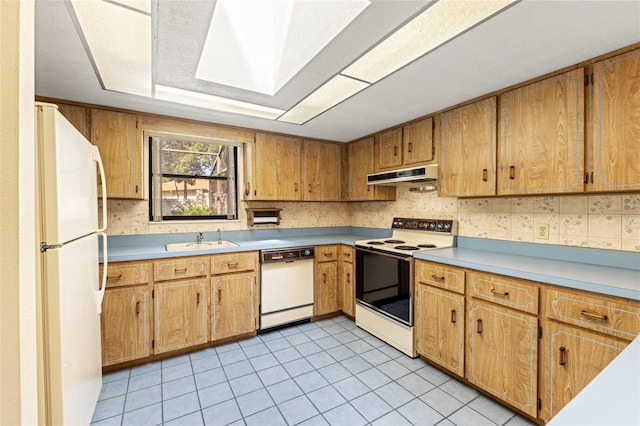 3029 Harrow Rd, Spring Hill, FL 34606 - kitchen featuring light countertops, a skylight, under cabinet range hood, and white appliances