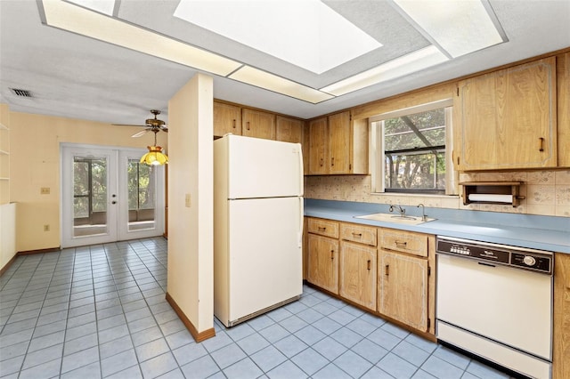 3029 Harrow Rd, Spring Hill, FL 34606 - kitchen with a sink, white appliances, light countertops, a skylight, and visible vents