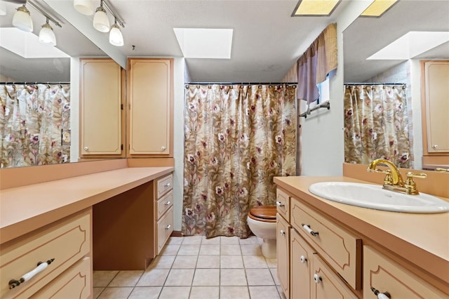 3029 Harrow Rd, Spring Hill, FL 34606 - bathroom featuring a skylight, vanity, tile patterned floors, and toilet
