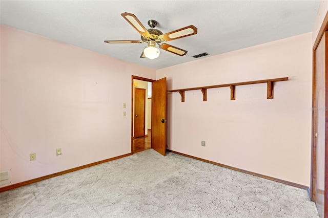 3029 Harrow Rd, Spring Hill, FL 34606 - spare room with visible vents, baseboards, ceiling fan, and light colored carpet